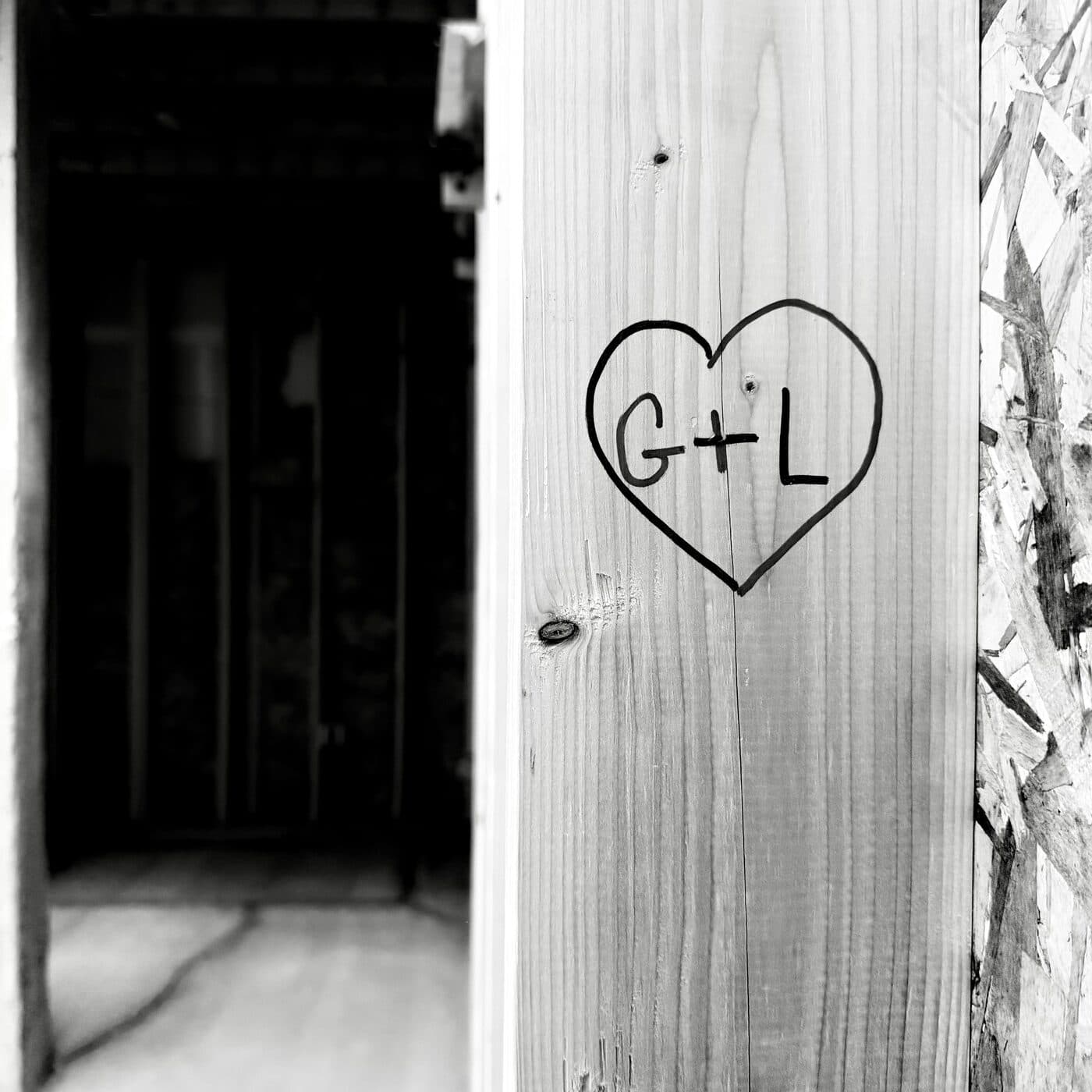 G and L carved inside a heart on one of the posts